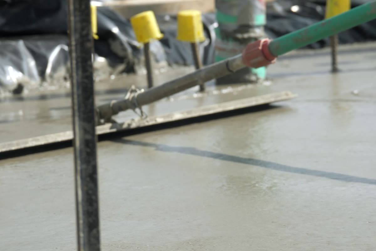 Concrete being screeded level